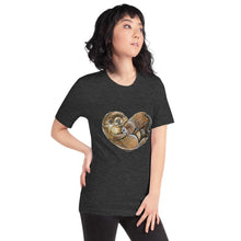Load image into Gallery viewer, A woman wearing the Otters Love Premium Unisex T-Shirt in the colour dark grey heather, which includes an image of two otters forming the shape of a heart.
