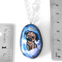 Load image into Gallery viewer, a beach stone pendant necklace, featuring dog art of a pug as an angel, next to two rulers to show its size:  1 7/16" x 1" or 3.6 cm x 2.5 cm
