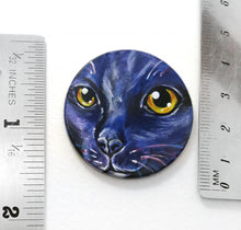 Load image into Gallery viewer, A wooden disc, with pet art of a cat, painted in purple and black, next to two rulers to show its size: 1 1/2" or 3.8 cm across
