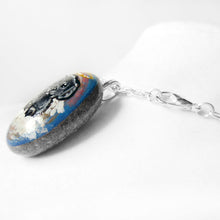 Load image into Gallery viewer, A small beach stone, hand painted with a portrait of a black shih tzu dog as an angel sitting in the clouds. Available as a keepsake, fridge magnet, or necklace
