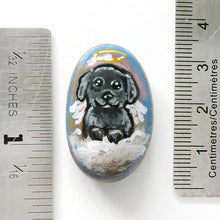 Load image into Gallery viewer, A small beach stone, hand painted with a portrait of a black shih tzu dog as an angel sitting in the clouds. Available as a keepsake, fridge magnet, or necklace
