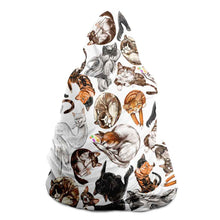 Load image into Gallery viewer, a man wears the Sleepy Cats Hooded Blanket, featuring illustrations of different sleeping cats
