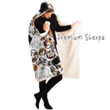 Load image into Gallery viewer, a man wears the Sleepy Cats Hooded Blanket, featuring illustrations of different sleeping cats, lined with premium sherpa
