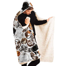 Load image into Gallery viewer, a man wears the Sleepy Cats Hooded Blanket, featuring illustrations of different sleeping cats, lined with premium sherpa
