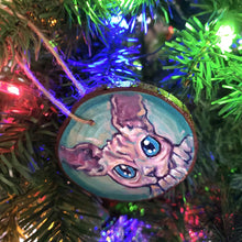 Load image into Gallery viewer, A handmade Christmas tree wood ornament, featuring a painting of a sphynx cat with blue eyes
