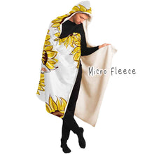 Load image into Gallery viewer, a man wears a white microfiber fleece hooded blanket, lined with micro fleece, printed with sunflower art, with a black cat and white cat peeking out from the flowers
