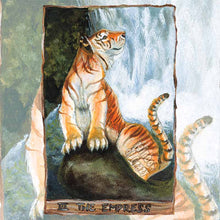 Load image into Gallery viewer, illustration of The Empress tarot card from The Animism Tarot deck, featuring a golden tiger, on a large rock at the base of a waterfall
