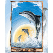 Load image into Gallery viewer, This art print features the Three of Cups tarot card from the Animism Tarot: three dusky dolphins jump out of the ocean, enjoying the warmth of the sun together.
