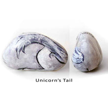 Load image into Gallery viewer, a stone hand painted with the portrait of a unicorn with purple eyes
