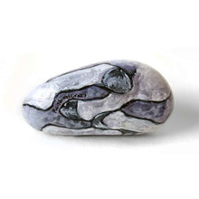 Load image into Gallery viewer, a stone hand painted with the portrait of a unicorn with purple eyes, its legs and hooves on the underside. signed with, rainbowofcrazy
