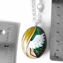 Load image into Gallery viewer, rock art featuring the virgo zodiac sign: a portrait of a woman's back, with angel wings and long blond hair. three sheaves of wheat lay next to her. available as a keepsake or pendant necklace
