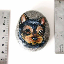 Load image into Gallery viewer, a beach stone, hand painted with the portrait of a black and brown yorkie's face
